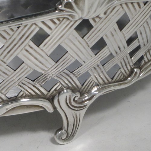 Antique Edwardian sterling silver jardinière, having an oval body with hand-pierced and engraved decoration in a basket-weave style, applied shell and scroll borders, with two cast floral handles, and sitting on four cast scroll feet. Made by Wakely & Wheeler of Chester in 1902. The dimensions of this fine hand-made silver table jardinière are length 35 cms (13.75 inches), width 20 cms (8 inches), height 11.5 cms (4.5 inches), and it weighs approx. 844g (27 troy ounces).