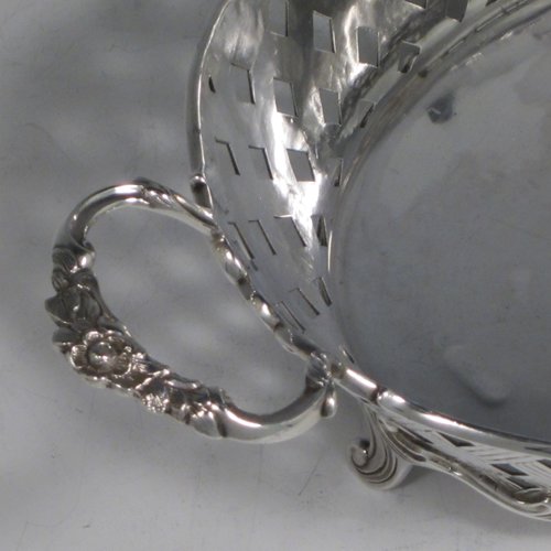 Antique Edwardian sterling silver jardinière, having an oval body with hand-pierced and engraved decoration in a basket-weave style, applied shell and scroll borders, with two cast floral handles, and sitting on four cast scroll feet. Made by Wakely & Wheeler of Chester in 1902. The dimensions of this fine hand-made silver table jardinière are length 35 cms (13.75 inches), width 20 cms (8 inches), height 11.5 cms (4.5 inches), and it weighs approx. 844g (27 troy ounces).
