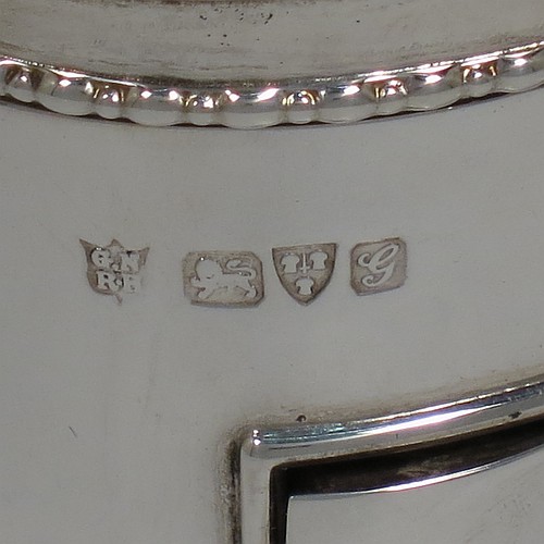 An Antique Edwardian Sterling Silver large jewellery box, having a rectangular shaped casket style body with rounded corners and applied pearl and bead borders, a plain domed hinged lid covering a velvet-lined interior, a pull-out drawer with a cast swing handle, and all sitting on four cast foliate feet. Made by Nathan and Hayes of Chester in 1907. The dimensions of this fine hand-made antique silver jewellery box are length 13.5 cms (5.3 inches), width 11 cms (4.3 inches), and height 11 cms (4.3 inches).