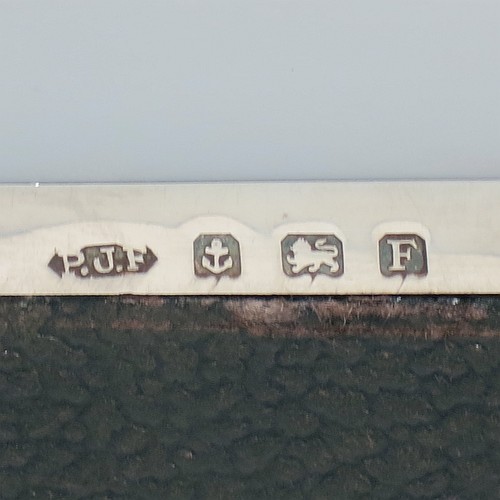 A large Art Deco Sterling Silver jewelery box, having a very plain rectangular body sitting on four corner feet, with angular hand-engraved top corners, a slightly concave and hinged lid with thumb-piece and gold-gilt interior, and the base with a light blue velvet lining. Made by Percy James Finch of Birmingham in 1930. The dimensions of this fine hand-made silver jewellery table box are height 5 cms (2 inches), length 18 cms (7 inches), and width 9 cms (3.7 inches).