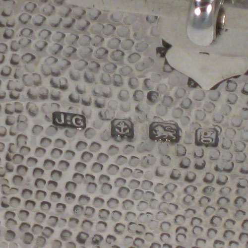 Antique Edwardian sterling silver Arts and Crafts style casket jewelery box, having a hand-hammered rectangular body, with cut-card work in a Medieval style, a hinged lock and chain, and a velvet lined interior. Made by J. Gilbert of Birmingham in 1906. Height 6.5 cms (2.5 inches), length 18.5 cms (7.25 inches), depth 10 cms (4 inches). Weight approx. 400g (13 troy ounces).