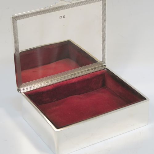 A very handsome Art Deco Sterling Silver jewelery box, having a very plain rectangular body, a hinged lid with engine-turned top border and thumb-piece, a maroon velvet-lined interior, and sitting on a flat base. This elegant and stylish jewellery box was made by Mappin and Webb of Birmingham in 1937. The dimensions of this fine hand-made silver jewellery table box are height 3.25 cms (1.25 inches), length 12 cms (4.75 inches), and width 9.5 cms (3.75 inches).