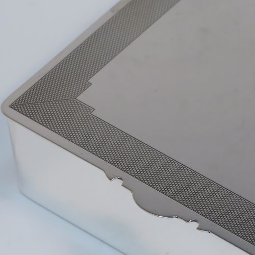 A very handsome Art Deco Sterling Silver jewelery box, having a very plain rectangular body, a hinged lid with engine-turned top border and thumb-piece, a maroon velvet-lined interior, and sitting on a flat base. This elegant and stylish jewellery box was made by Mappin and Webb of Birmingham in 1937. The dimensions of this fine hand-made silver jewellery table box are height 3.25 cms (1.25 inches), length 12 cms (4.75 inches), and width 9.5 cms (3.75 inches).
