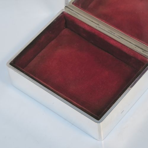 A very handsome Art Deco Sterling Silver jewelery box, having a very plain rectangular body, a hinged lid with engine-turned top border and thumb-piece, a maroon velvet-lined interior, and sitting on a flat base. This elegant and stylish jewellery box was made by Mappin and Webb of Birmingham in 1937. The dimensions of this fine hand-made silver jewellery table box are height 3.25 cms (1.25 inches), length 12 cms (4.75 inches), and width 9.5 cms (3.75 inches).