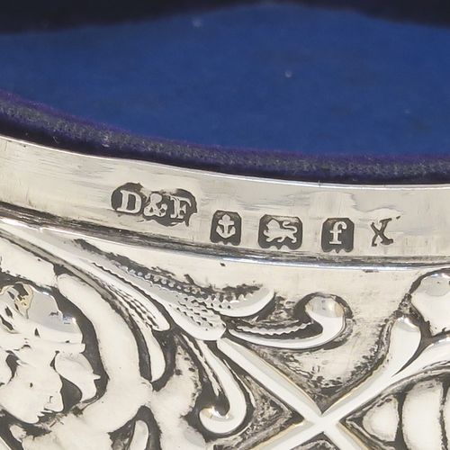 A very beautiful Antique Edwardian Silver jewelery box, having a round body with straight sides and hand-chased floral and cherub face decoration, a hinged lid with a group of hand-chased Seraphims, a gold gilt and dark-blue velvet and satin-lined interior, and all sitting on four cast cabriolet feet. This pretty antique silver jewellery box was made by Deakin and Francis of Birmingham in 1905. The dimensions of this fine hand-made antique silver jewellery box are diameter 11 cms (4.25 inches), and height 6 cms (2.25 inches)