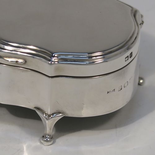 A very handsome Antique Sterling Silver jewelery box, having a dressing table style plain rectangular bow-fronted body, a plain flat topped hinged lid with a reeded border, a gold gilt and maroon velvet-lined interior, and all sitting on four cabriolet feet. This elegant antique silver jewellery box was made by A. and J. Zimmerman of Birmingham in 1914. The dimensions of this fine hand-made antique silver jewellery box are width 9 cms (3.5 inches), depth 6.5 cms (2.5 inches), and height 4 cms (1.5 inches)