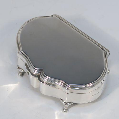 A very handsome Antique Sterling Silver jewelery box, having a dressing table style plain rectangular bow-fronted body, a plain flat topped hinged lid with a reeded border, a gold gilt and maroon velvet-lined interior, and all sitting on four cabriolet feet. This elegant antique silver jewellery box was made by A. and J. Zimmerman of Birmingham in 1914. The dimensions of this fine hand-made antique silver jewellery box are width 9 cms (3.5 inches), depth 6.5 cms (2.5 inches), and height 4 cms (1.5 inches)