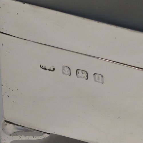 A very handsome Antique Sterling Silver jewelery box, having a dressing table style plain rectangular bow-fronted body, a plain and slightly domed hinged, a gold gilt and dark blue satin-lined interior, and all sitting on four cabriolet feet. This elegant antique silver jewellery box was made by Deakin and Francis of Birmingham in 1919. The dimensions of this fine hand-made antique silver jewellery box are width 13 cms (5 inches), depth 8 cms (3 inches), and height 5 cms (2 inches)