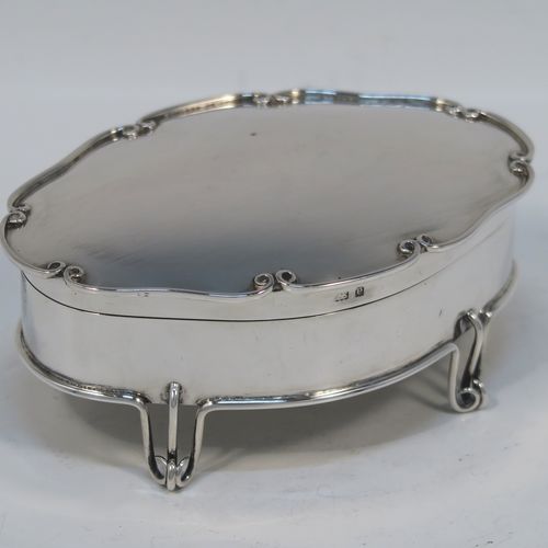 An unusual and elegant Antique Edwardian Sterling Silver jewelery box, having a plain oval-shaped body with straight sides, a slightly domed hinged lid with an applied wire-work scroll border, a gold gilt interior, and all sitting on four wire-work feet. This beautiful silver jewellery box was made by Deakin and Francis of Birmingham in 1904. The dimensions of this fine hand-made antique silver jewellery box are length 11 cms (4.25 inches), width 7.5 cms (3 inches), height 4.5 cms (1.75 inches), and it weight approx. 100g (3.2 troy ounces).   