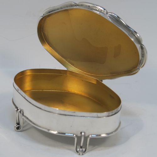 An unusual and elegant Antique Edwardian Sterling Silver jewelery box, having a plain oval-shaped body with straight sides, a slightly domed hinged lid with an applied wire-work scroll border, a gold gilt interior, and all sitting on four wire-work feet. This beautiful silver jewellery box was made by Deakin and Francis of Birmingham in 1904. The dimensions of this fine hand-made antique silver jewellery box are length 11 cms (4.25 inches), width 7.5 cms (3 inches), height 4.5 cms (1.75 inches), and it weight approx. 100g (3.2 troy ounces).   