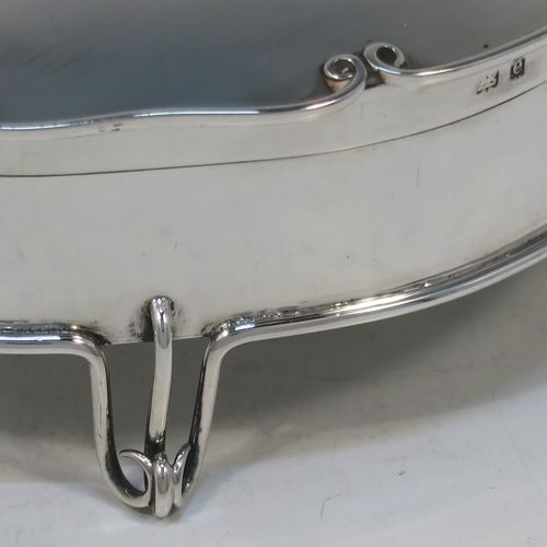 An unusual and elegant Antique Edwardian Sterling Silver jewelery box, having a plain oval-shaped body with straight sides, a slightly domed hinged lid with an applied wire-work scroll border, a gold gilt interior, and all sitting on four wire-work feet. This beautiful silver jewellery box was made by Deakin and Francis of Birmingham in 1904. The dimensions of this fine hand-made antique silver jewellery box are length 11 cms (4.25 inches), width 7.5 cms (3 inches), height 4.5 cms (1.75 inches), and it weight approx. 100g (3.2 troy ounces).   