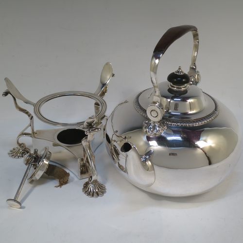 A very handsome Antique Victorian Sterling Silver tea kettle on a burner stand, having a plain round bellied body with an applied gadroon border, a lift-off lid with wooden finial, a leather covered hinged handle, and sitting on an original burner stand with removable central wick and three cast shell feet. Made by Joshua Vander of London in 1893. The dimensions of this fine hand-made antique silver kettle are length 21 cms (8.25 inches), height 27.5 cms (10.75 inches), width 18 cms (7 inches), and the total weight is approx. 770g (24.8 troy ounces).