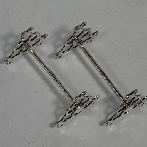 A very pretty Antique Sterling Silver pair of knife rests, with hand-pierced and scroll style rest ends, and plain round central struts. Made by James Dixon Sheffield in 1913. The dimensions of this fine hand-made pair of antique silver knife rests are length 7 cms (2.75 inches), height 4 cms (1.5 inches), and they weigh a total of approx. 47g (1.5 troy ounces).