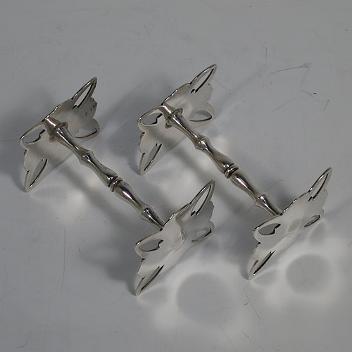 A very handsome pair of Antique Edwardian Sterling Silver knife rests, with cut square-shaped and hand-pierced rest ends, and round baluster central struts. Made by Charles Edwards of London in 1906. The dimensions of this fine hand-made pair of antique silver knife rests are length 7 cms (2.75 inches), height 4 cms (1.5 inches), and they weigh a total of approx. 92g (3 troy ounces).