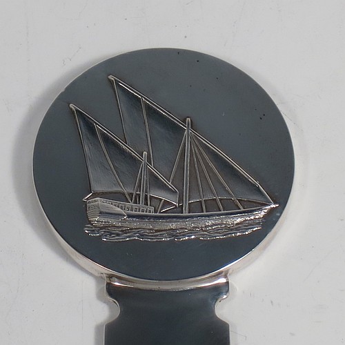 A very stylish Silver-Plated letter or envelope opener, having a very plain straight-sided blade with tapering point, attached to a heavy round handle with one side having a hand-chased schooner ship, and the reverse with a view of the Kuwaiti water towers. Made by Christofle of Paris, France, in circa. 1980. The dimensions of this fine hand-made silver plated envelope or letter opener are length 22 cms (8.6 inches), and diameter of handle 5 cms (2 inches).