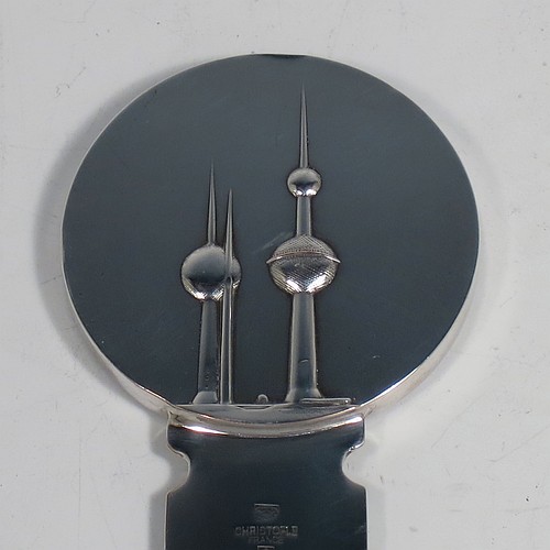 A very stylish Silver-Plated letter or envelope opener, having a very plain straight-sided blade with tapering point, attached to a heavy round handle with one side having a hand-chased schooner ship, and the reverse with a view of the Kuwaiti water towers. Made by Christofle of Paris, France, in circa. 1980. The dimensions of this fine hand-made silver plated envelope or letter opener are length 22 cms (8.6 inches), and diameter of handle 5 cms (2 inches).