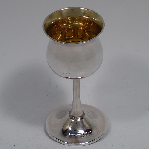 A very handsome Antique Sterling Silver set of six liqueor tots or measures, having plain round bellied goblet style bodies with gold-gilt interiors, sitting on round pedestal feet, and all fitted in their original green satin and velvet-lined presentation box. Made by Philip Hanson Abbot of London in 1912. The dimensions of this fine hand-made antique silver liqueur tots are height 7.5 cms (3 inches), diameter 3.5 cms (1.3 inches), and the total weight is approx. 208g (6.7 troy ounces).