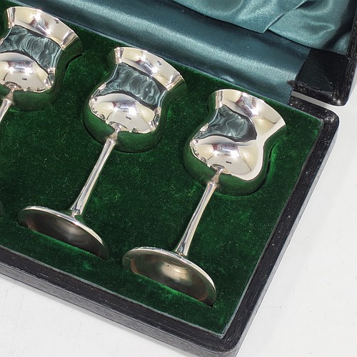 A very handsome Antique Sterling Silver set of six liqueor tots or measures, having plain round bellied goblet style bodies with gold-gilt interiors, sitting on round pedestal feet, and all fitted in their original green satin and velvet-lined presentation box. Made by Philip Hanson Abbot of London in 1912. The dimensions of this fine hand-made antique silver liqueur tots are height 7.5 cms (3 inches), diameter 3.5 cms (1.3 inches), and the total weight is approx. 208g (6.7 troy ounces).
