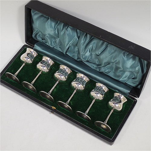 A very handsome Antique Sterling Silver set of six liqueor tots or measures, having plain round bellied goblet style bodies with gold-gilt interiors, sitting on round pedestal feet, and all fitted in their original green satin and velvet-lined presentation box. Made by Philip Hanson Abbot of London in 1912. The dimensions of this fine hand-made antique silver liqueur tots are height 7.5 cms (3 inches), diameter 3.5 cms (1.3 inches), and the total weight is approx. 208g (6.7 troy ounces).