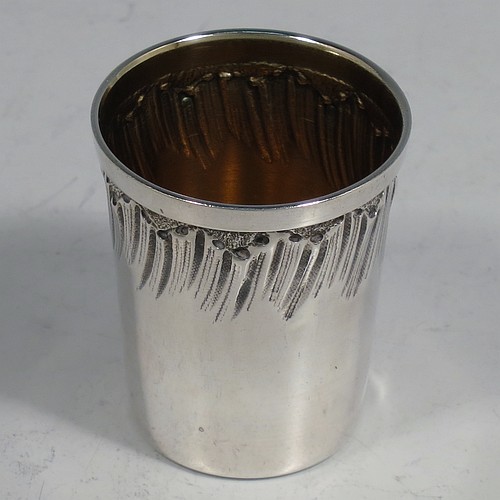 An Antique Victorian French First Quality Standard (950 std) sterling silver set of six liqueor tots / measures and original serving salver, the tots having round straight-sided bodies with gold-gilt interiors and hand-chased swirl-fluted upper borders, the salver with a plain ground and an applied cast foliate border. Made in France in ca. 1890. The dimensions of this fine hand-made antique silver liqueur set are height of tots 4 cms (1.5 inches), length of serving tray 20 cms (8 inches), and the total weight is approx. 285g (9.2 troy ounces).