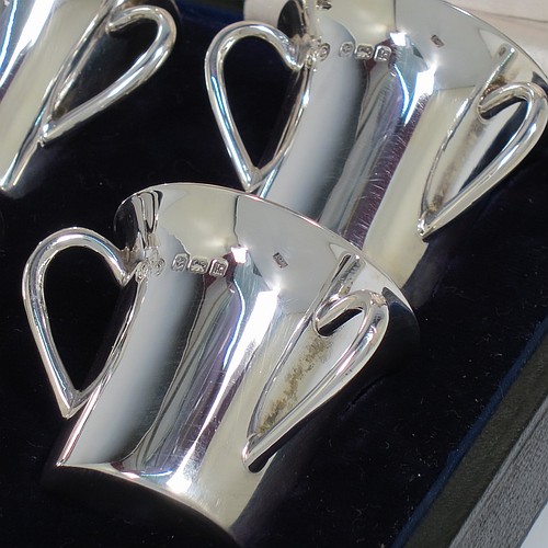 An Antique Edwardian Sterling Silver set of six liqueor tots or measures, round straight-sided bodies with three loop side-handles, all in their original cream satin and dark blue velvet-lined presentation box. Made by Elkington and Co., of Birmingham in 1909. The dimensions of this fine hand-made antique silver liqueur set are height 4 cms (1.5 inches), diameter 4 cms (1.5 inches), and the total weight is approx. 195g (6.3 troy ounces).