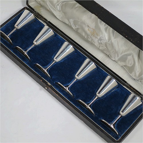 A handsome Antique Edwardian Sterling Silver set of six liqueor tots or measures, having very plain round bodies with tapering sides, sitting on round pedestal feet, and all fitted in their original satin and blue velvet-lined presentation box. Made by Walker and Hall of Birmingham in 1908. The dimensions of this fine hand-made antique silver liqueur tots are height 7.5 cms (3 inches), diameter at base 4.5 cms (1.75 inches), and the total weight is approx. 143g (4.6 troy ounces).