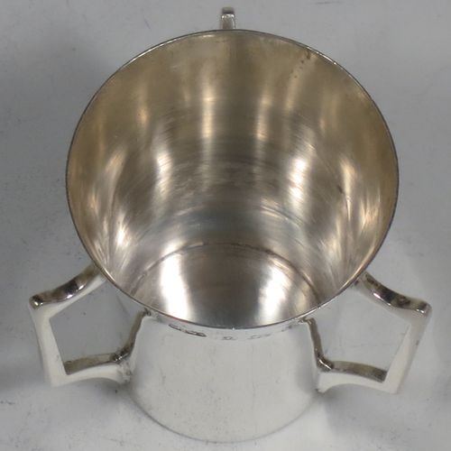 A handosme Antique Sterling Silver set of six liqueor tots or measures, having plain round bodies with tapering sides, three side-handles, and sitting on flat bases. Made by Mappin and Webb of Birmingham in 1915. The dimensions of this fine hand-made antique silver liqueur tot set are height 4 cms (1.5 inches), diameter at lip 4 cms (1.5 inches), and their total weight is approx. 165g (5.3 troy ounces).    