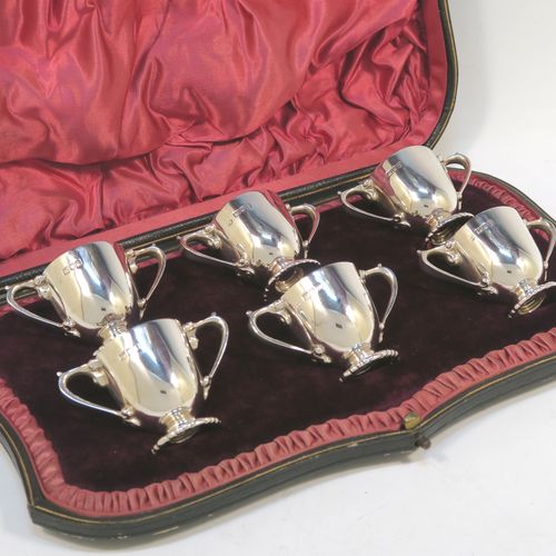 A very handsome Antique Edwardian Sterling Silver set of six liqueur tots or measures, having round trophy style bodies, with two loop side-handles, and sitting on pedestal feet, all in their original maroon satin and velvet-lined presentation box. This beautiful antique set of silver tots were made by Whakeley and Wheeler of London in 1904. The dimensions of this fine hand-made antique silver liqueur set are height 4 cms (1.5 inches), diameter 3.5 cms (1.3 inches), and the total weight is approx. 223g (7.2 troy ounces).  