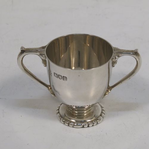 A very handsome Antique Edwardian Sterling Silver set of six liqueur tots or measures, having round trophy style bodies, with two loop side-handles, and sitting on pedestal feet, all in their original maroon satin and velvet-lined presentation box. This beautiful antique set of silver tots were made by Whakeley and Wheeler of London in 1904. The dimensions of this fine hand-made antique silver liqueur set are height 4 cms (1.5 inches), diameter 3.5 cms (1.3 inches), and the total weight is approx. 223g (7.2 troy ounces).