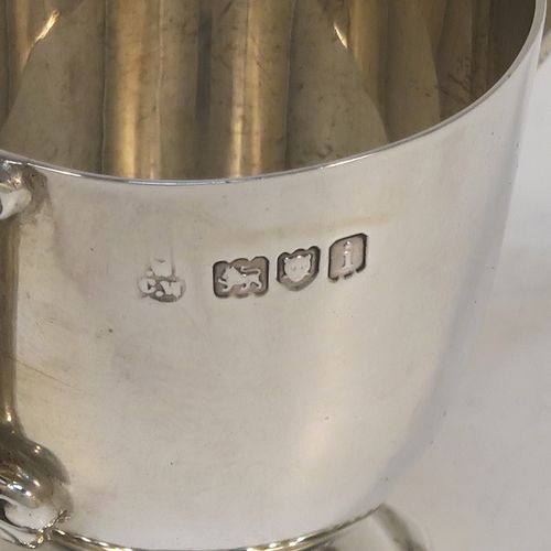 A very handsome Antique Edwardian Sterling Silver set of six liqueur tots or measures, having round trophy style bodies, with two loop side-handles, and sitting on pedestal feet, all in their original maroon satin and velvet-lined presentation box. This beautiful antique set of silver tots were made by Whakeley and Wheeler of London in 1904. The dimensions of this fine hand-made antique silver liqueur set are height 4 cms (1.5 inches), diameter 3.5 cms (1.3 inches), and the total weight is approx. 223g (7.2 troy ounces).