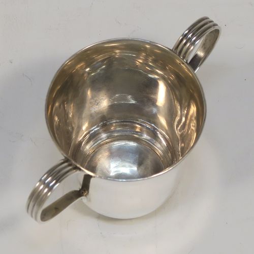 A handsome Antique Sterling Silver set of six liqueor tots or measures in a porringer style, having plain round bodies with tapering sides, two reeded side-handles, and sitting on flat bases. This elegant set of liqueur measures were made by Vale Brothers and Sermon of Birmingham in 1913. The dimensions of this fine hand-made antique silver liqueur tot set are height 4.5 cms (1.75 inches), diameter at lip 4 cms (1.5 inches), and their total weight is approx. 159g (5 troy ounces).
