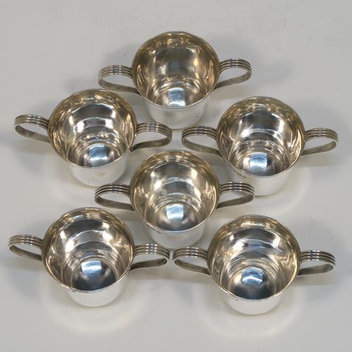 A handsome Antique Sterling Silver set of six liqueor tots or measures in a porringer style, having plain round bodies with tapering sides, two reeded side-handles, and sitting on flat bases. This elegant set of liqueur measures were made by Vale Brothers and Sermon of Birmingham in 1913. The dimensions of this fine hand-made antique silver liqueur tot set are height 4.5 cms (1.75 inches), diameter at lip 4 cms (1.5 inches), and their total weight is approx. 159g (5 troy ounces).