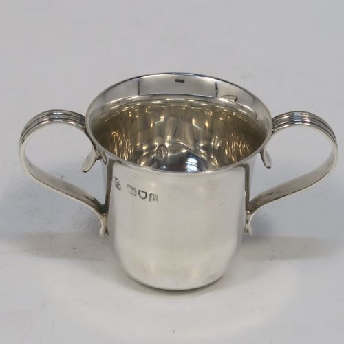 A handsome Antique Edwardian Sterling Silver set of six liqueor tots or measures in a porringer style, having plain round bodies with tapering sides, two reeded side-handles, and sitting on flat bases, all in their original cream satin and dark blue velvet presentation box. This elegant set of liqueur measures were made by Wakely and Wheeler of London in 1903. The dimensions of this fine hand-made antique silver liqueur tot set are height 4 cms (1.5 inches), diameter at lip 4 cms (1.5 inches), and their total weight is approx. 189g (6 troy ounces).   