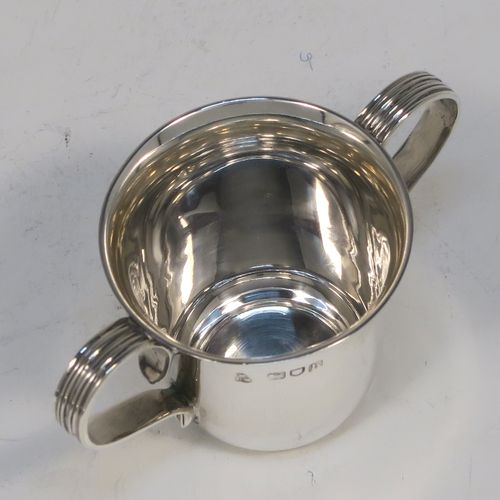 A handsome Antique Edwardian Sterling Silver set of six liqueor tots or measures in a porringer style, having plain round bodies with tapering sides, two reeded side-handles, and sitting on flat bases, all in their original cream satin and dark blue velvet presentation box. This elegant set of liqueur measures were made by Wakely and Wheeler of London in 1903. The dimensions of this fine hand-made antique silver liqueur tot set are height 4 cms (1.5 inches), diameter at lip 4 cms (1.5 inches), and their total weight is approx. 189g (6 troy ounces).   