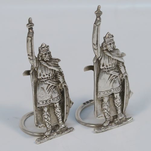 A handsome and rare pair of King Arthur Sterling Silver place card holders, having cast figural bodies, and sitting on circular wire-work bases. This elegant pair of silver menu or place card holders were made by F. J. Ross and Sons of London in 1937. The dimensions of this fine pair of silver King Arthur figural place card holders are height 7.5 cms (3 inches), diameter of ring bases 2.5 cms (1 inch), and they weigh a total of approx. 49g (1.6 troy ounces).   