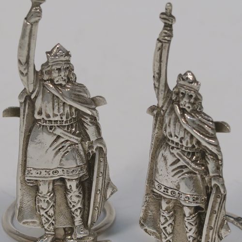 A handsome and rare pair of King Arthur Sterling Silver place card holders, having cast figural bodies, and sitting on circular wire-work bases. This elegant pair of silver menu or place card holders were made by F. J. Ross and Sons of London in 1937. The dimensions of this fine pair of silver King Arthur figural place card holders are height 7.5 cms (3 inches), diameter of ring bases 2.5 cms (1 inch), and they weigh a total of approx. 49g (1.6 troy ounces).
