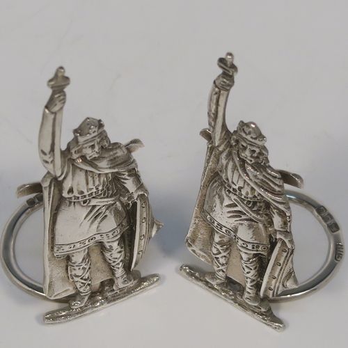 A handsome and rare pair of King Arthur Sterling Silver place card holders, having cast figural bodies, and sitting on circular wire-work bases. This elegant pair of silver menu or place card holders were made by F. J. Ross and Sons of London in 1937. The dimensions of this fine pair of silver King Arthur figural place card holders are height 7.5 cms (3 inches), diameter of ring bases 2.5 cms (1 inch), and they weigh a total of approx. 49g (1.6 troy ounces).