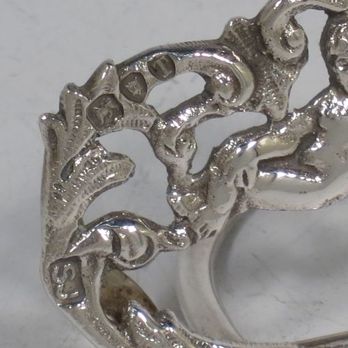 A very pretty Antique Victorian Sterling Silver set of four place card holders, having cast bodies with reclining cherubs over scroll and floral decoration, and sitting on half-circle wire-work bases. Made by Samuel Jacob of London in 1894. The dimensions of this fine set of antique silver place card holders are width 7 cms (2.75 inches), height 4 cms (1.5 inches), depth 3 cms (1.25 inches), and they weigh a total of approx. 106g (3.4 troy ounces).
