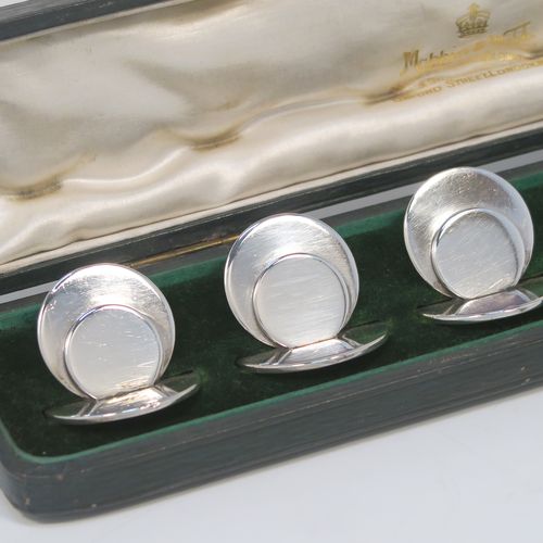 A very handsome and heavy Antique Sterling Silver set of six place card holders, having very plain round bodies, and all in their original white satin and dark-green velvet-lined presentation box. These beautiful silver place card holders were made by Sampson and Morden of Chester in 1911. The dimensions of this fine hand-made set of antique silver place card holders are diameter of bases 3 cms (1.25 inches), height 3 cms (1.25 inches), and they weigh a total of approx. 162g (5.2 troy ounces).