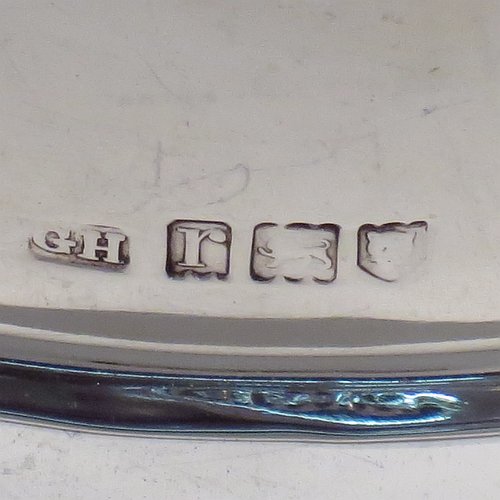 An Antique Sterling Silver muffin dish, having a plain round body with reeded border, a domed lift-off lid with wooden finial, an interior lift-out liner with space underneath for hot water or crushed ice, and sitting on a flat base. Made by Harrison Brothers & Howson of in 1912. The dimensions of this fine hand-made antique silver muffin dish are diameter 18.5 cms (7.3 inches), height 11.5 cms (4.5 inches), and it weighs approx. 486g (15.7 troy ounces).