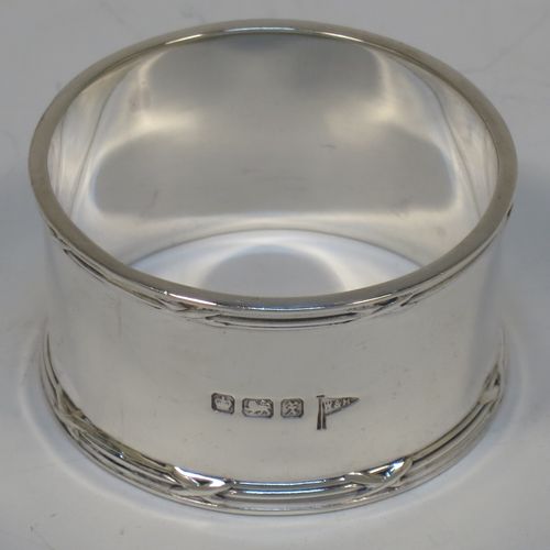 A very handsome Antique Sterling Silver set of six napkin rings, having plain round bodies with straight sides, with applied ribbon and reed borders, all in their original light blue satin and dark-blue velvet-lined presentation box. Made by Walker and Hall of Sheffield in 1915. The dimensions of these fine hand-made antique silver napkin rings are diameter 5 cms (2 inches), height 2.5 cms (1 inch), and they weigh a total of approx. 232g (7.5 troy ounces).