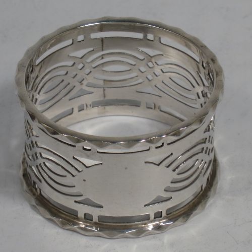 A pretty Antique Sterling Silver set of six napkin rings, having round straight-sided bodies, with hand-pierced geometrical style decoration, a central oval vacant cartouche, and with applied faceted borders, all in their original maroon satin and velvet-lined presentation box. Made by Ferganbaum and Son of Birmingham in 1921. The dimensions of these fine hand-made silver napkin rings are diameter 4.5 cms (1.75 inches), height 2.5 cms (1 inch), and they weigh a total of approx. 140g (4.5 troy ounces).