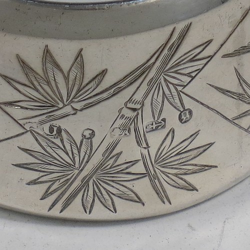 A very pretty Antique Victorian Aesthetic style Sterling Silver pair of napkin rings, having round straight-sided bodies with turned-over borders, and each one hand-engraved differently with Aesthetic decoration of birds, butterflies and bamboo shoots, all in their original cream satin and dark blue velvet-lined presentation box. Made by George Unite of Birmingham in 1881. The dimensions of these fine hand-made antique silver napkin rings are diameter 5 cms (2 inches), height 3 cms (1.25 inches), and they weigh a total of approx. 48g (1.5 troy ounces).
