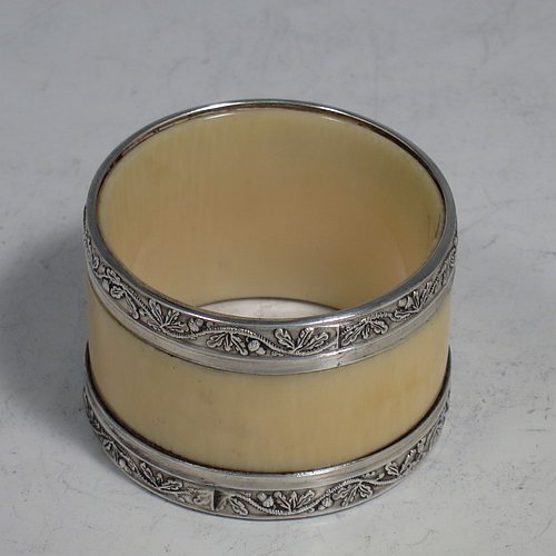 An Antique Victorian Silver-Plated and bone set of four napkin rings and two knife rests, the napkin rings having round straight-sided bodies with applied bands of floral decoration, the knife rests having cast floral supports with button ends, all in their original maroon satin and velvet-lined presentation box. Made by Elkington & Co., in ca. 1880. The dimensions of these fine hand-made antique silver plated and bone napkin rings are diameter 4.5 cms (1.75 inches), height 3 cms (1.25 inch), and the knife rests are 8.5 cms (3.3 inches) long by 4 cms (1.5 inches) high.