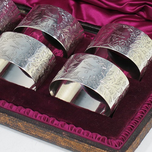 A very pretty Antique Victorian Sterling Silver set of six napkin rings, having oval-shaped bodies with straight sides and hand-engraved ferns and gingko leaves surrounding a cartouche on one side, all in their original maroon satin and velvet-lined presentation box. Made by Edward Hutton of London in 1891. The dimensions of these fine hand-made antique silver napkin rings are length 5 cms (2 inches), height 3 cms (1.25 inch), and they weigh a total of approx. 166g (5 troy ounces). Please note that these items are crested and numbered 1 to 6.   