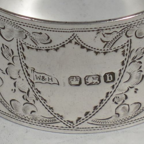 A very pretty Antique Victorian Sterling Silver set of four napkin rings, having round bodies with straight sides, hand-engraved floral and scroll decoration with two vacant shaped shield style cartouches, all in their original light blue satin and dark blue velvet-lined presentation box. Made by Walker and Hall of Sheffield in 1894. The dimensions of these fine hand-made antique silver-plated napkin rings are diameter 4.5 cms (1.75 inches), height 2.5 cms (1 inch), and they weigh a total of approx. 119g (3.8 troy ounces).