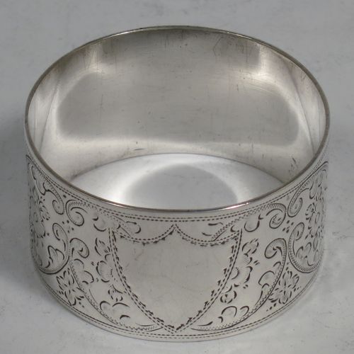 A very pretty Antique Victorian Sterling Silver set of four napkin rings, having round bodies with straight sides, hand-engraved floral and scroll decoration with two vacant shaped shield style cartouches, all in their original light blue satin and dark blue velvet-lined presentation box. Made by Walker and Hall of Sheffield in 1894. The dimensions of these fine hand-made antique silver-plated napkin rings are diameter 4.5 cms (1.75 inches), height 2.5 cms (1 inch), and they weigh a total of approx. 119g (3.8 troy ounces).