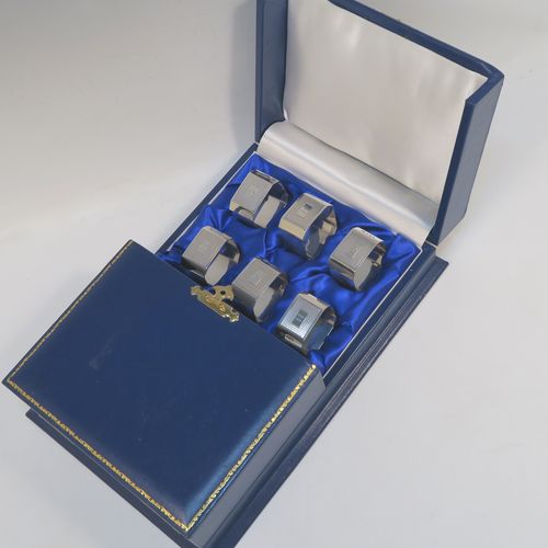A very handsome and rare set of twelve Art Deco Sterling Silver napkin rings, having square bodies with chamfered corners and engine-turned engraving, all in their original cream and dark blue satin presentation box. This beautiful set of twelve silver napkin rings were made by Richard Richardson (poss.) of Birmingham in 1935. The dimensions of these fine hand-made and heavy Art Deco silver napkin rings are length 5 cms (2 inches) square, and they weigh a total of approx. 508g (16.4 troy ounces). Please note that these items are numbered 1 to 12.