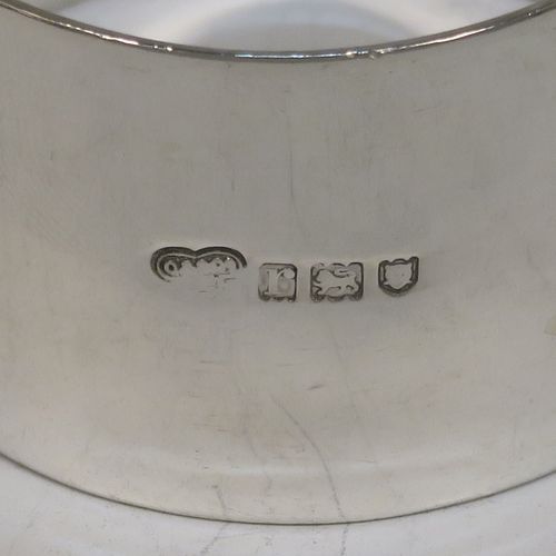 A very handsome Antique Sterling Silver set of six napkin rings, having plain round bodies with straight sides, all in their original maroon satin and velvet-lined presentation box. Made by Goldsmiths and Silversmiths of London in 1912. The dimensions of these fine hand-made antique silver napkin rings are diameter 4.5 cms (1.75 inches), height 3 cms (1.25 inches), and they weigh a total of approx. 285g (9.2 troy ounces).