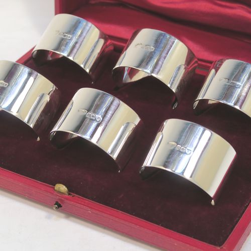 A very handsome Antique Sterling Silver set of six napkin rings, having plain round bodies with straight sides, all in their original maroon satin and velvet-lined presentation box. Made by Goldsmiths and Silversmiths of London in 1912. The dimensions of these fine hand-made antique silver napkin rings are diameter 4.5 cms (1.75 inches), height 3 cms (1.25 inches), and they weigh a total of approx. 285g (9.2 troy ounces).